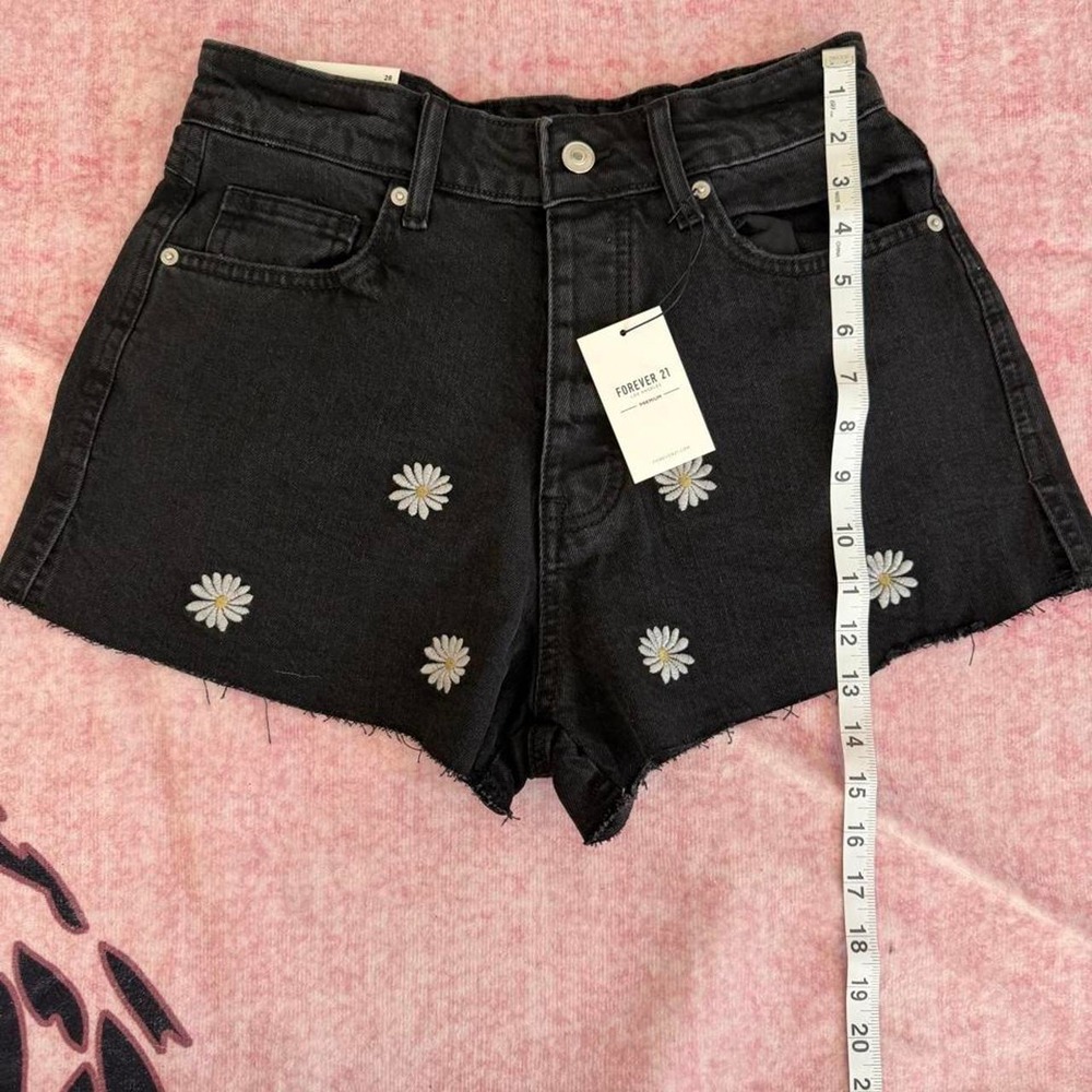 Forever 21 black denim shorts with white daisy embroidery,